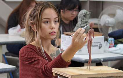 Student working on sculpture